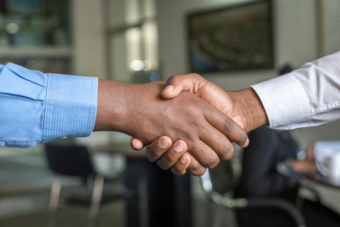 Two people shaking hands after a meeting