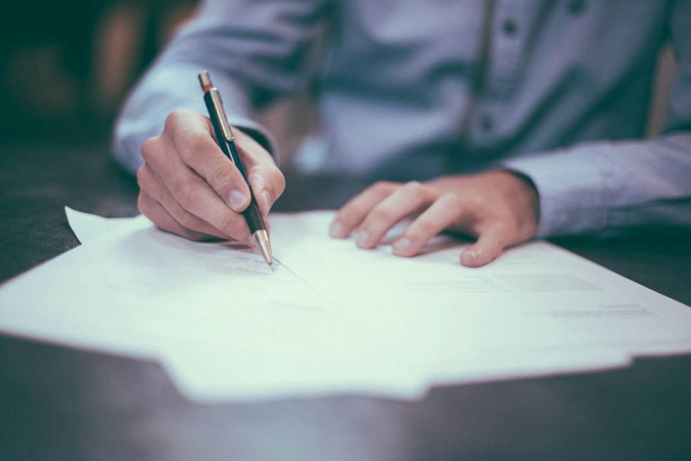 Person reviewing paperwork at a desk
